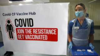 Nurse with vaccines sign