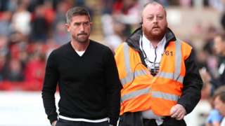 Harry Kewell escorted to the stands after his sending off at Exeter
