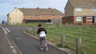 A boy plays in an area of deprivation