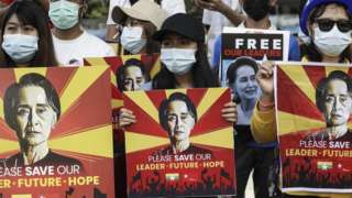 Protesters hold placards calling for the release of detained Myanmar State Counselor Aung San Suu Kyi