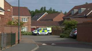 Police van next to homes