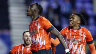 Elijah Adebayo's injury time goal seals the 2-1 win for Luton over Wigan in their FA Cup third round replay at the DW Stadium.