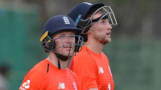 England captain Eoin Morgan and batsman Joe Root walk off after bad light interrupts play against a Sri Lanka Cricket XI