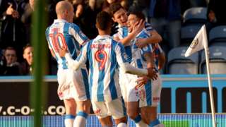 Huddersfield Town's players celebrate Nahki Wells' injury-minute equaliser