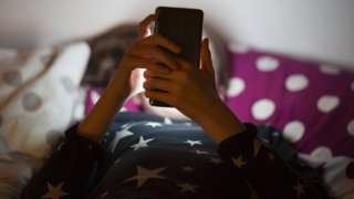 Anonymous girl using phone