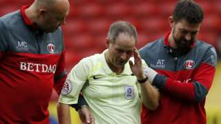 Robert Lewis is left concussed in a collision while refereeing Charlton v Doncaster