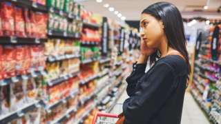 Woman looking sad in supermarket