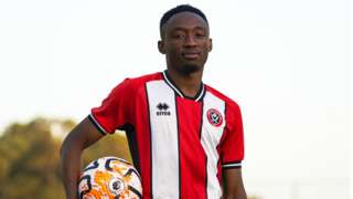 Benie Traore holding a football