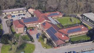 Fromeside as shown from above. Red-roofed building with gardens.