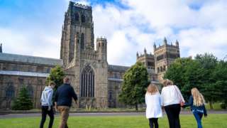 Family walks towards cathedral