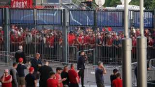 Liverpool fans queue to gain entry to the stadium as Kick off is delayed ahead of the UEFA Champions League Final at the Stade de France