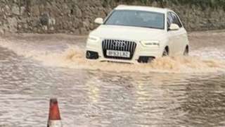 Car driving through flooded road