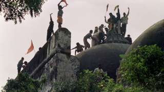 In this file photograph taken on December 6, 1992 Hindu youths clamour atop the 16th century Muslim Babri Mosque five hours before the structure was demolished by hundreds supporting Hindu fundamentalist activists.