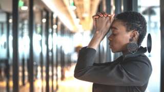 Stock image of a stressed business woman