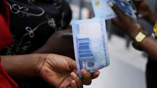 People holding the new 1,000 naira note in Abuja, Nigeria - 15 December 2022