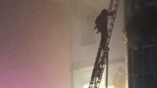 Baby being rescued from hotel fire