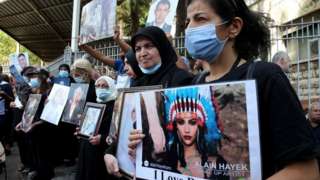 Relatives of those killed in the Beirut port explosion protest against pressure put on Tarek Bitar outside the Palais de Justice in Beirut, Lebanon (24 September 2021)