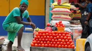 A tomato seller is awaiting buyers as many raw food vendors are recording low sales during the Ramadan period in Ogba, Lagos, Nigeria, on March 24
