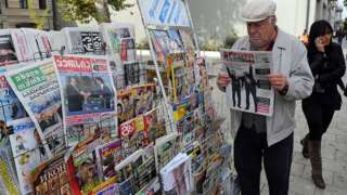 A man reads a newspaper in Georgia's capital Tbilisi, on October 28, 2013