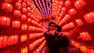 A man takes a picture of himself and a child during the Lantern Festival in Taiyuan, northern China. Photo: 26 February 2021