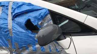 Car with makeshift window repair