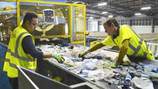 Employees sort waste at the Lampton 360 Recycling Centre