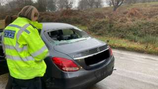 Car with shattered back window following crash with cyclist in Richmond Park