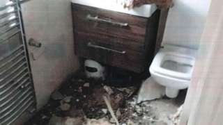 Bathroom with debris from collapsed ceiling