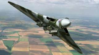 Vulcan bomber flying in the air over countryside