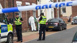 Police and forensics outside a property