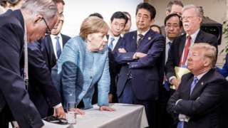 German Chancellor Angela Merkel deliberates with US president Donald Trump on the sidelines of the official agenda on the second day of the G7