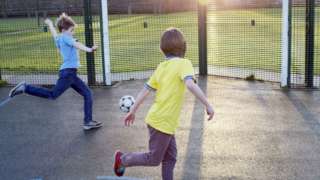 Stock image of children playing football