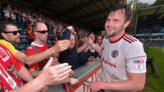 Accrington captain Mark Hughes celebrates with fans