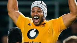 Nizaam Carr celebrates