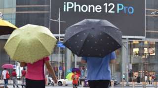 An iPhone 12 Pro logo seen displayed on a large screen outside the Apple store on Wangfujing Street in Beijing.
