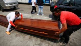 Empty coffins, for the 34 bodies that have been identified so far after the massacre of 68 prisoners, are transferred to the morgue, in Guayaquil, Ecuador, 14 November 2021