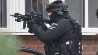 An armed officer at the scene