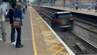 A car on a track at Cheshunt railway station, Hertfordshire, in June 2021