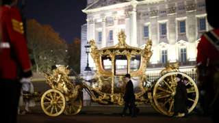 The Gold State Coach is ridden alongside members of the military during a full overnight dress rehearsal of the Coronation.