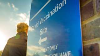 Man walking into Covid vaccination centre