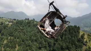Pakistan cable car dangling