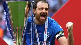 Portsmouth captain Brett Pitman lifts the Checkatrade Trophy