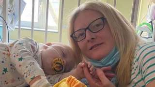 Ewan and his mum Jodie in hospital