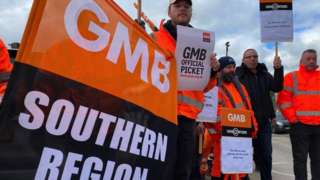 GMB refuse workers on strike holding the GMB southern region flag
