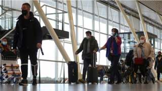 People walk inside Schiphol Airport