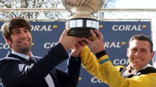 Trainer Christian Williams and jockey Robert James lift the trophy after Win My Wings wins the Scottish Grand National