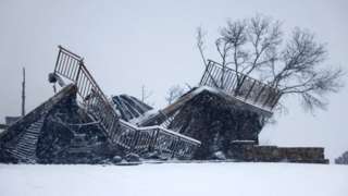 A burned out house buried under snow after a wildfire in Colorado