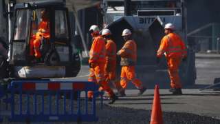 Construction workers work near the Excel Centre, London in the Docklands as the spread of the coronavirus disease (COVID-19) continues, London, Britain, March 24, 2020.