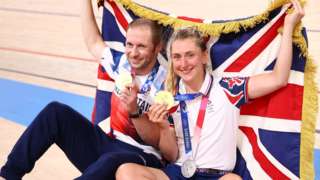 Jason Kenny and his wife Laura of Team GB pose with their medals and a Union flag