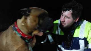 Rescued dog and coastguard